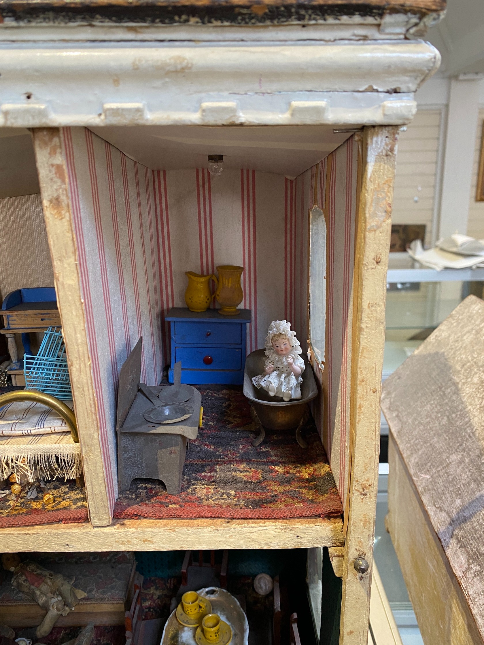 ‘Queens Lynn House’. A late 19th century home-made dolls' house, and contents, 66cm high